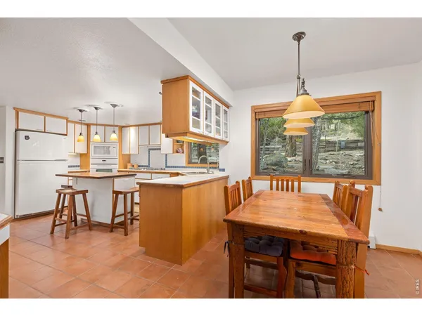 a dining room with furniture a chandelier and wooden floor