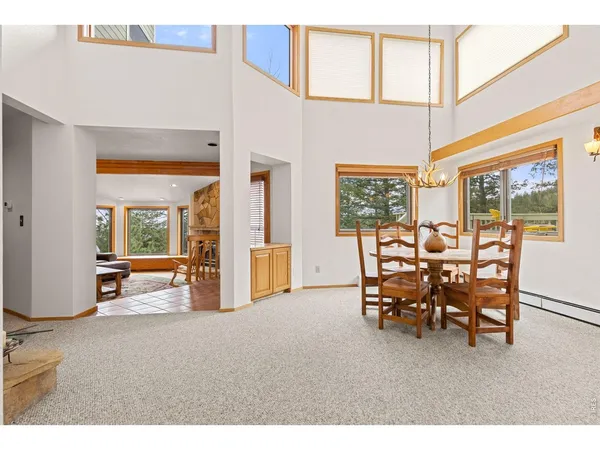 a dining room with furniture and a large window