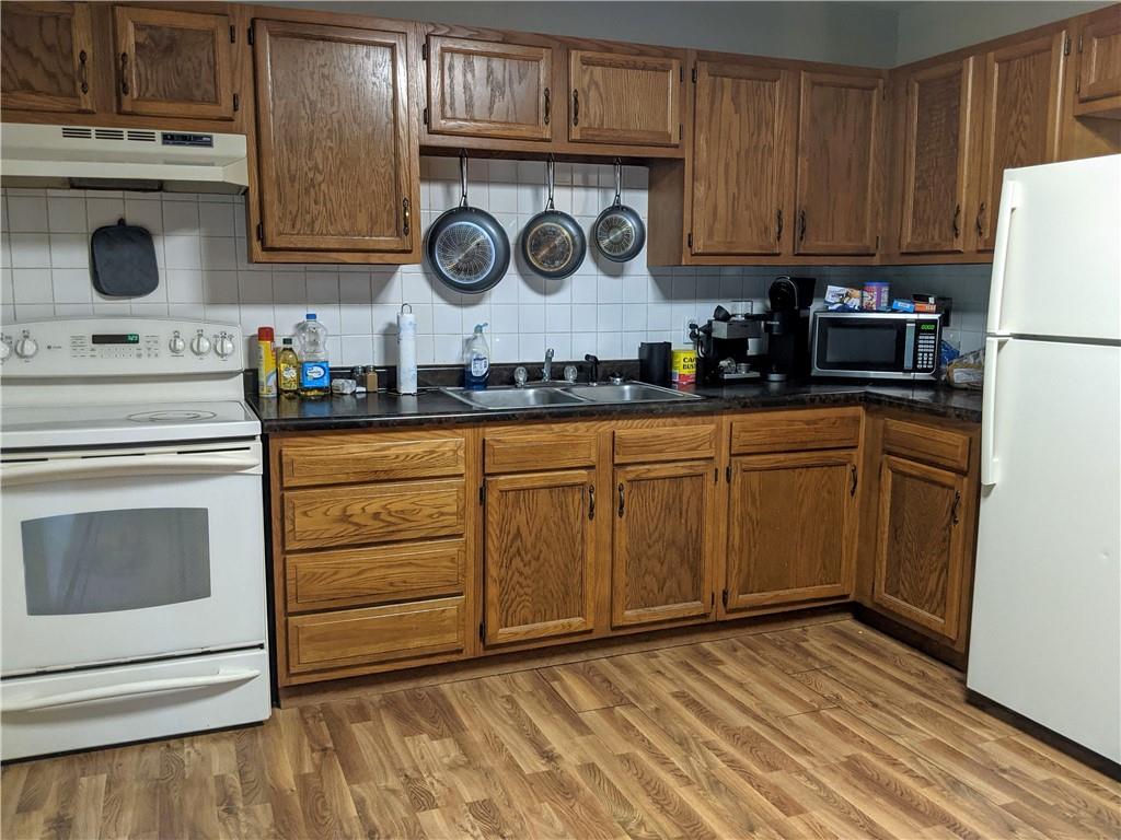 281 West Mountainview Road Acme, PA 15610 - Photo 8 of 25 a kitchen with stainless steel appliances granite countertop a stove a sink and a white cabinets with wooden floor