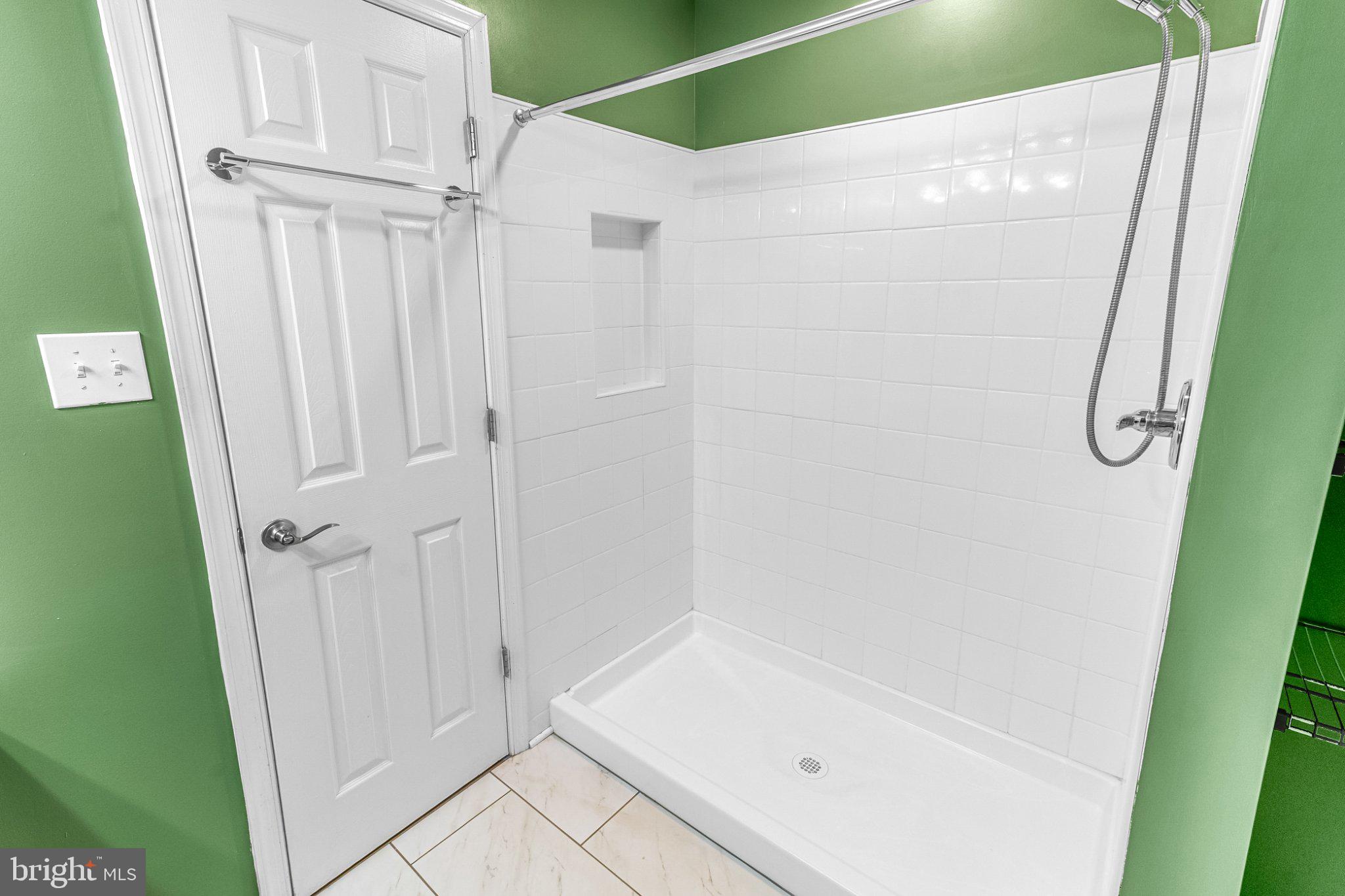 2471 Sulphur Springs Road Inwood, WV 25428 - Photo 11 of 44 Sleek shower space with vibrant walls.