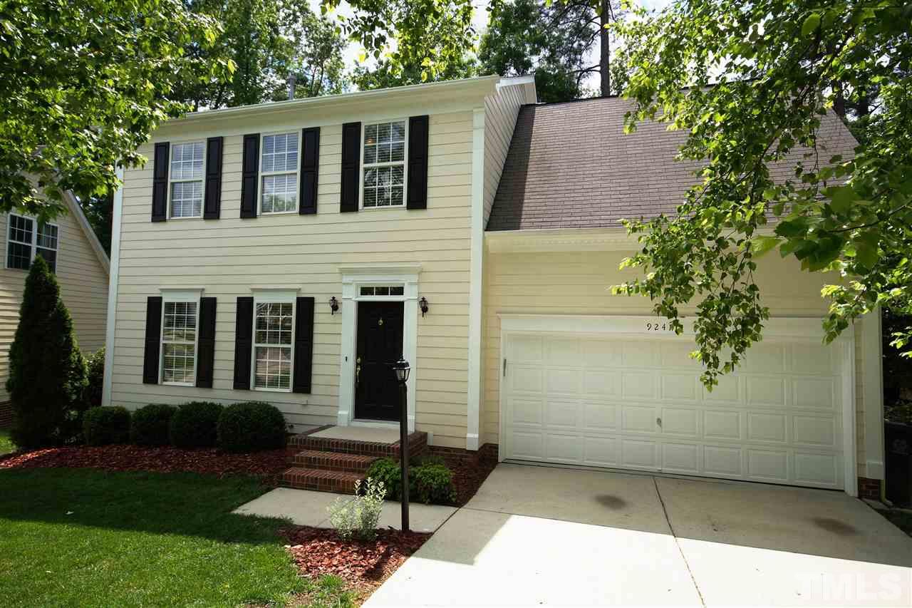 9241 Shallcross Way Raleigh, NC 27617 - Photo 1 of 22 a front view of a house with garden