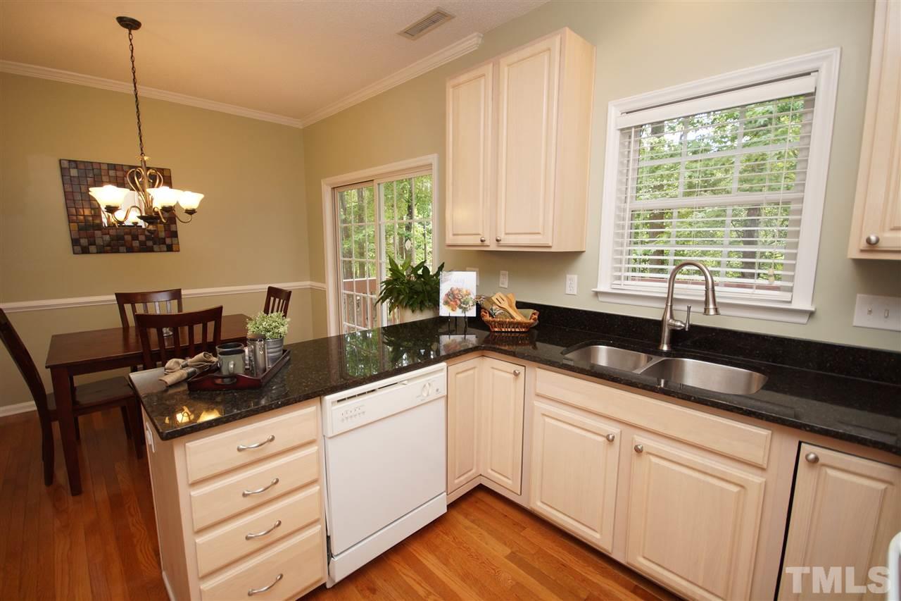 9241 Shallcross Way Raleigh, NC 27617 - Photo 12 of 22 a kitchen with stainless steel appliances granite countertop a sink a stove and a wooden floors