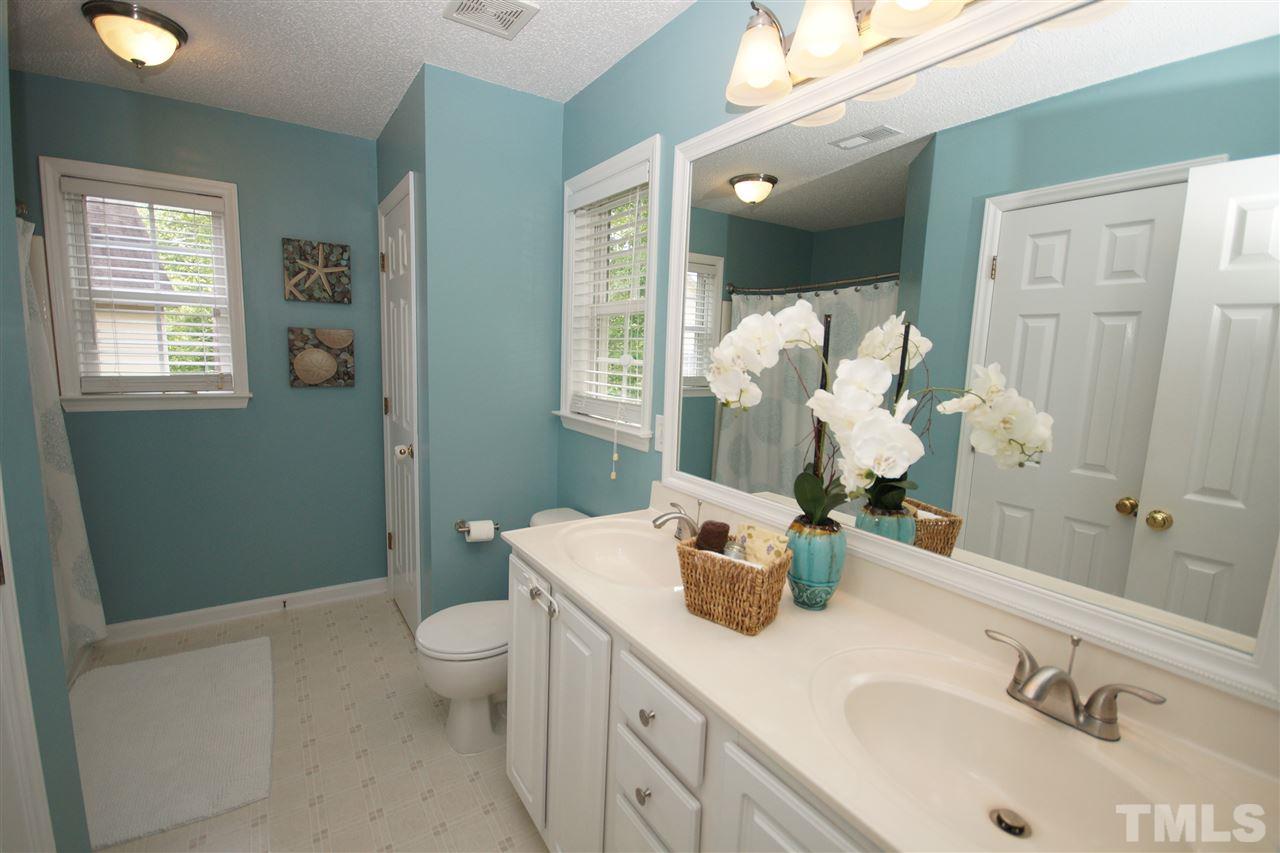 9241 Shallcross Way Raleigh, NC 27617 - Photo 14 of 22 a bathroom with a sink double vanity and mirror