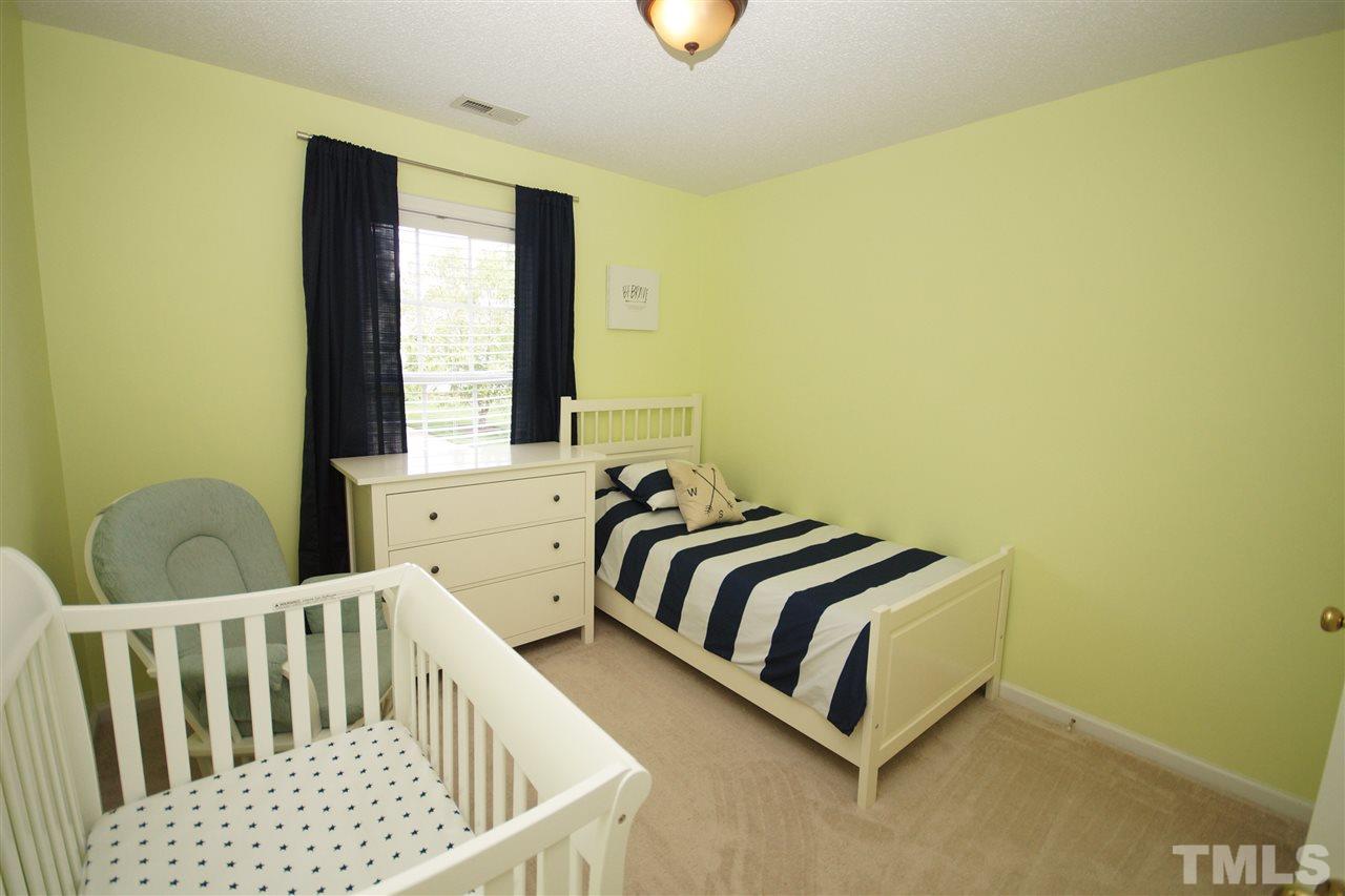 9241 Shallcross Way Raleigh, NC 27617 - Photo 15 of 22 a bedroom with a bed and window