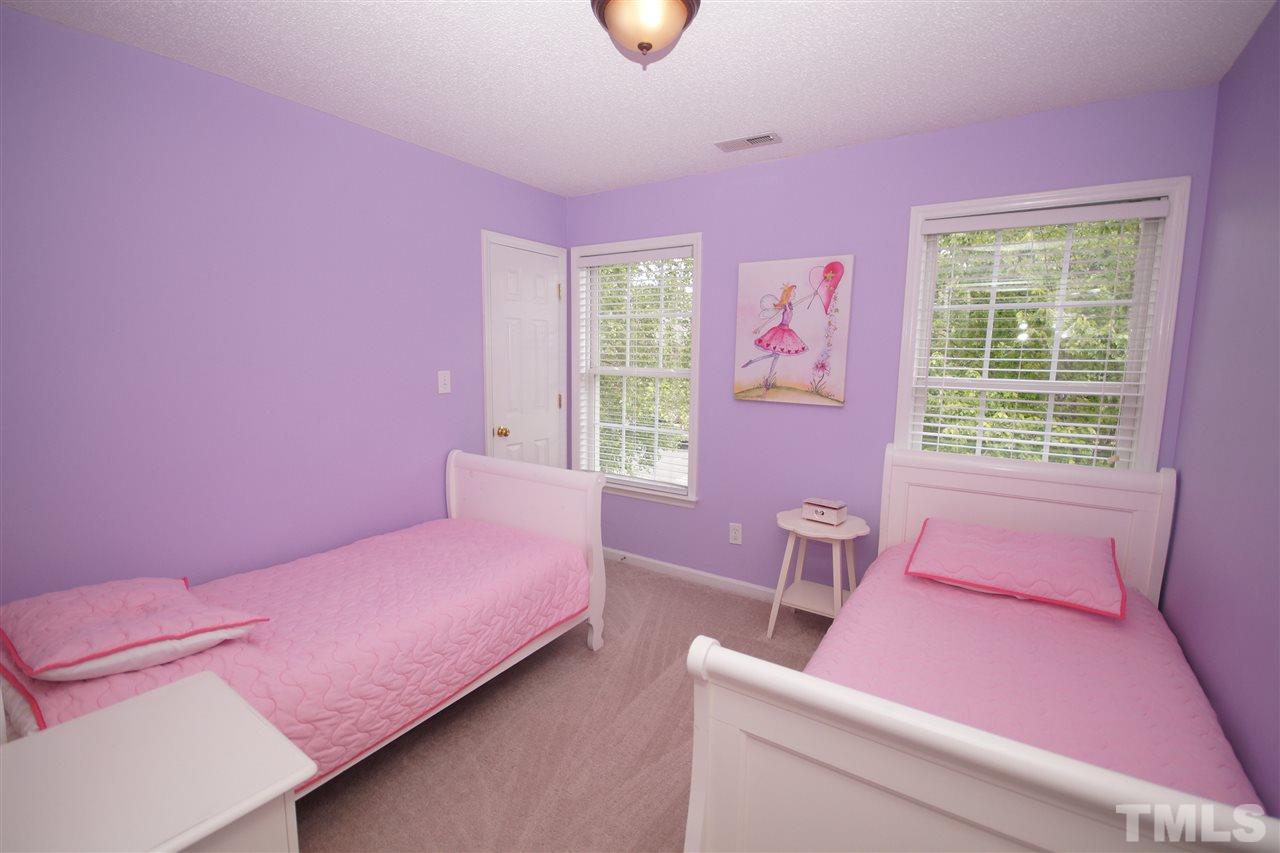 9241 Shallcross Way Raleigh, NC 27617 - Photo 16 of 22 a bedroom with a bed and a window