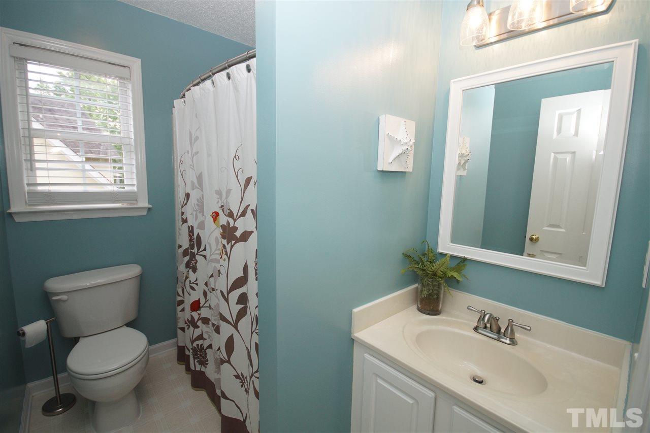 9241 Shallcross Way Raleigh, NC 27617 - Photo 17 of 22 a bathroom with a toilet sink and mirror
