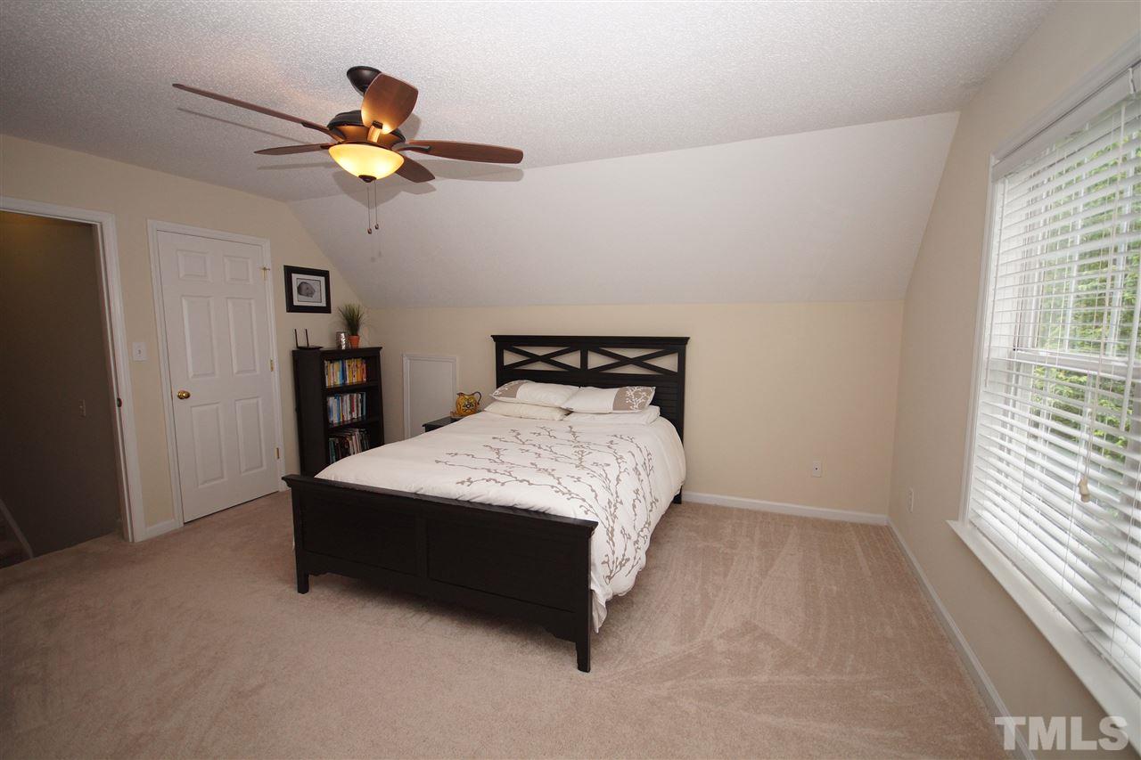 9241 Shallcross Way Raleigh, NC 27617 - Photo 18 of 22 a bed sitting in a bedroom next to a window