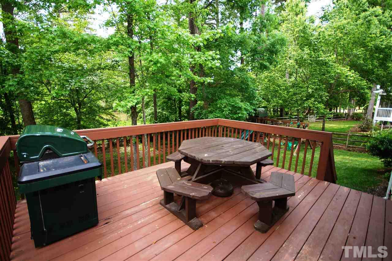 9241 Shallcross Way Raleigh, NC 27617 - Photo 19 of 22 a view of a deck with wooden floor and outdoor seating