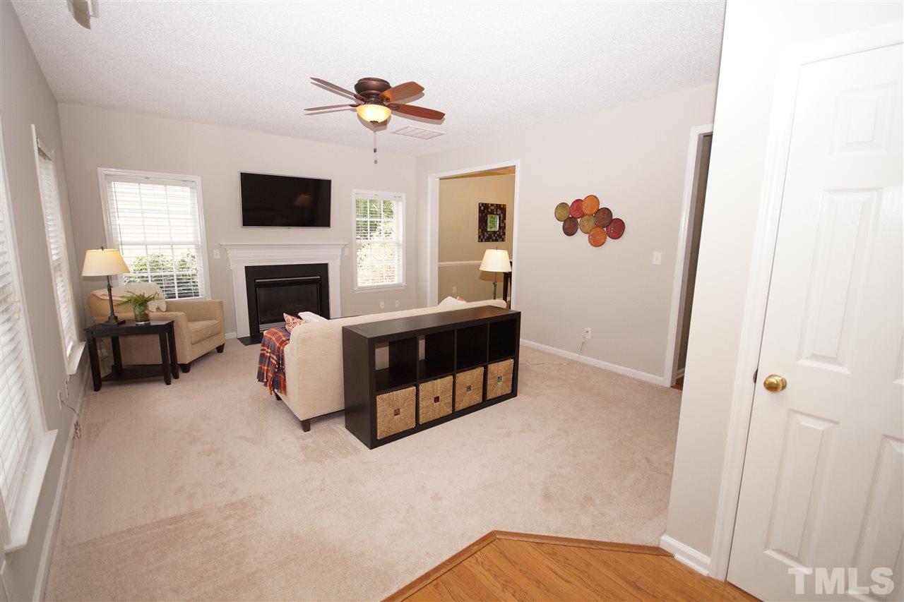 9241 Shallcross Way Raleigh, NC 27617 - Photo 3 of 22 a living room with furniture and a fireplace