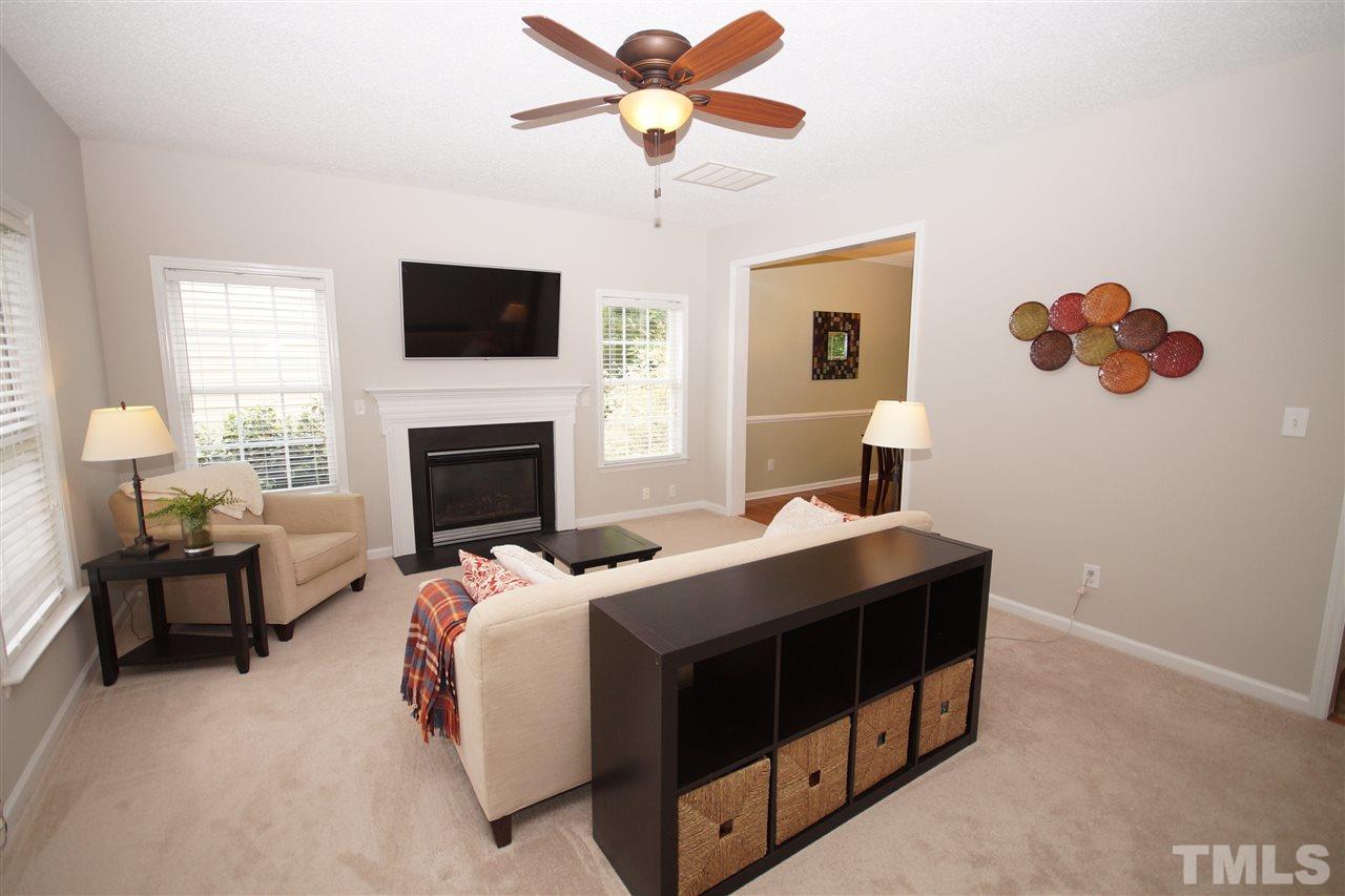 9241 Shallcross Way Raleigh, NC 27617 - Photo 4 of 22 a bedroom with a bed and a fireplace