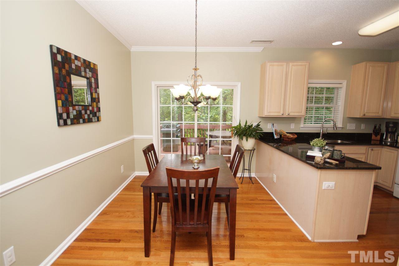 9241 Shallcross Way Raleigh, NC 27617 - Photo 9 of 22 a view of a dining room with furniture window and wooden floor