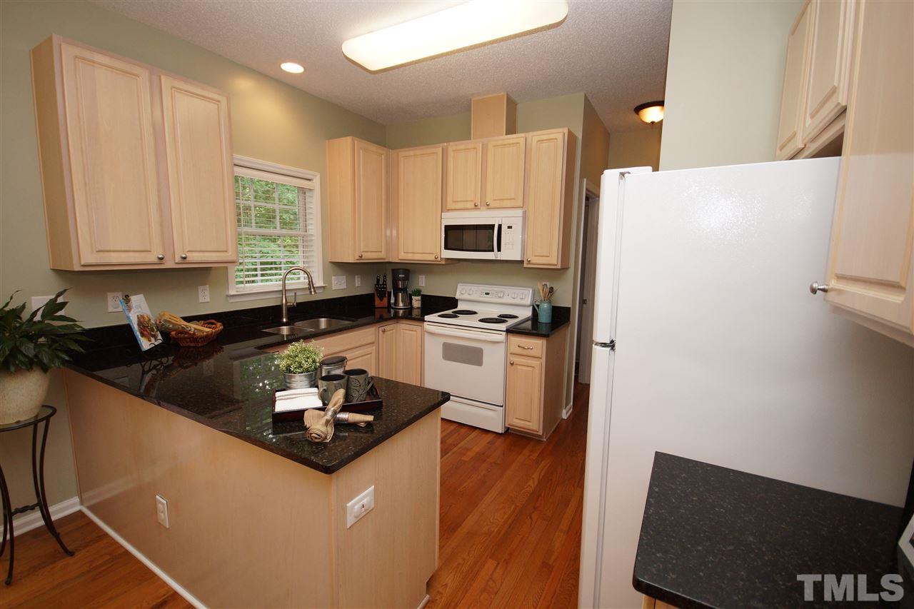 9241 Shallcross Way Raleigh, NC 27617 - Photo 10 of 22 a kitchen with a sink a stove a refrigerator and a microwave