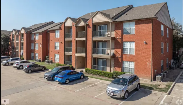 a car parked in front of a brick house