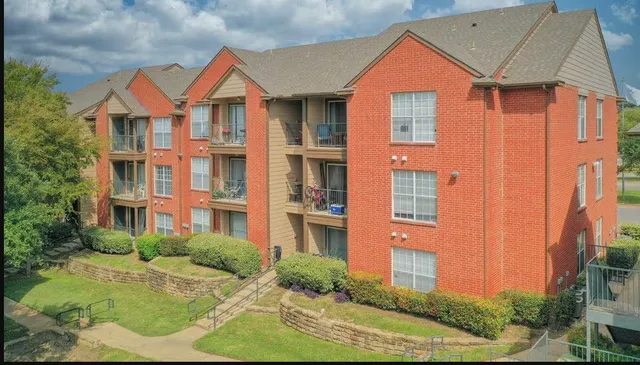 a front view of a residential apartment building with a yard