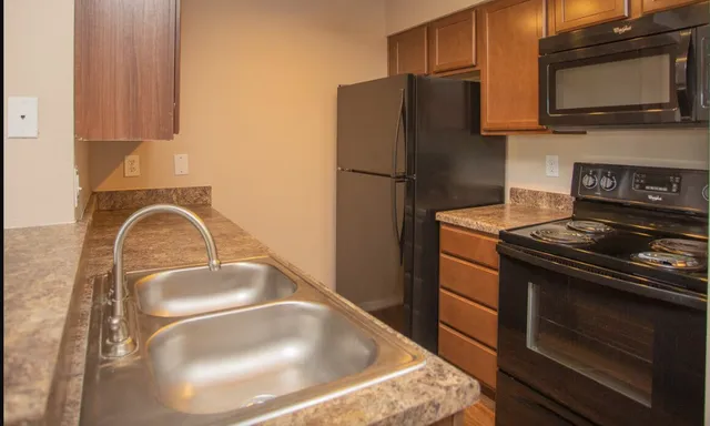 a kitchen with a refrigerator stove and microwave