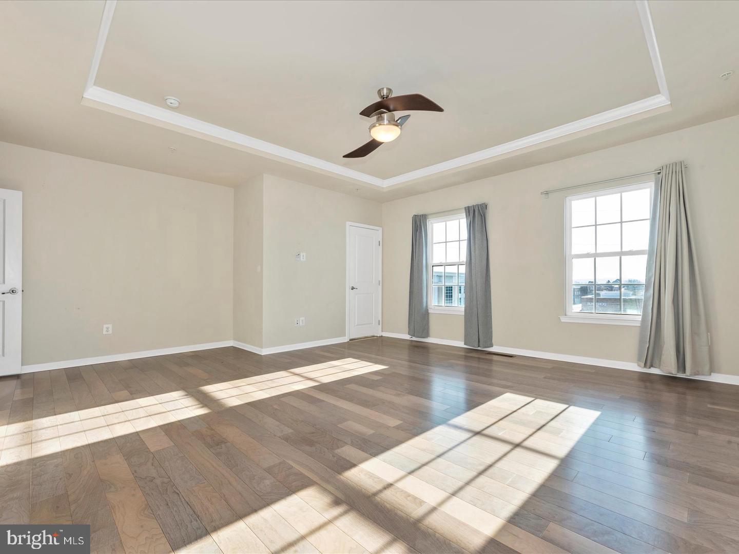 208 B Mill Pond Road Frederick, MD 21701 - Photo 25 of 45 a view of an empty room with a window and wooden floor