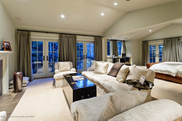 a living room with patio furniture and a flat screen tv