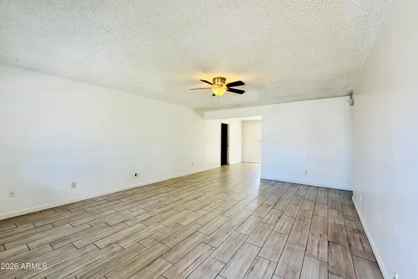 a view of an empty room and wooden floor