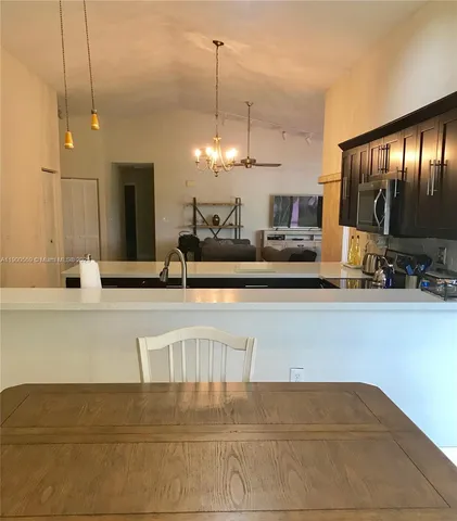 a view of a living room and kitchen