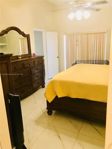 a bed sitting in a bedroom and dresser