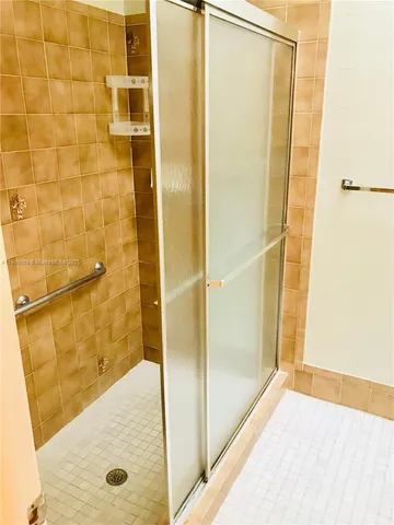 a view of a patio with dining table chairs and iron fence