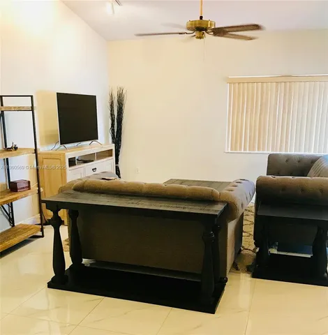 a living room with a couch and a flat screen tv