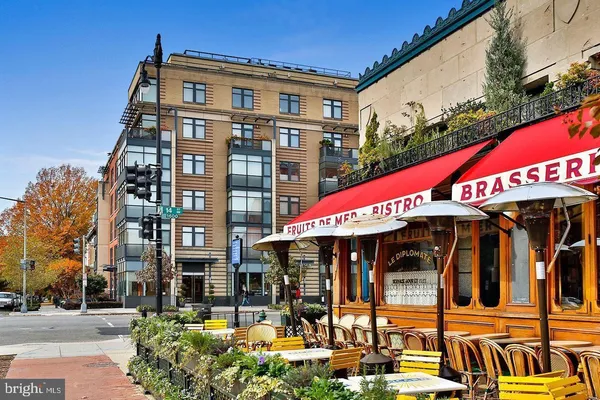 a view of a building with a bench in a patio