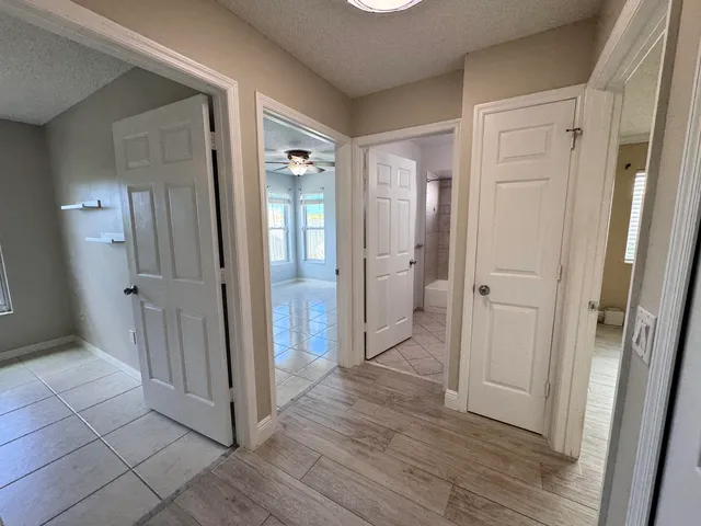 a view of a hallway with wooden floor
