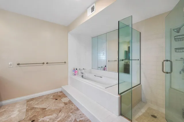 a bathroom with a bathtub and a shower