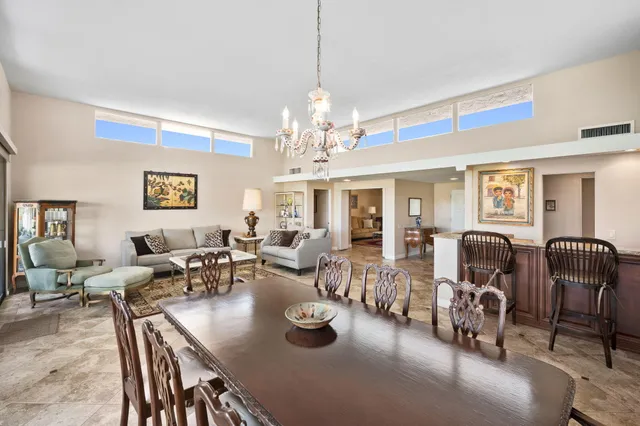 a living room with lots of furniture and a chandelier