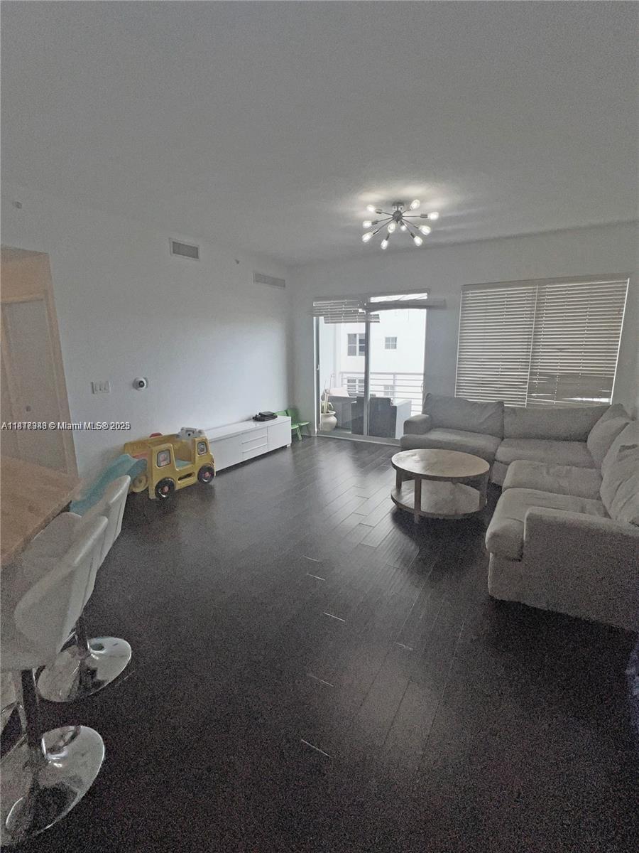 Royal Poinciana Hollywood, FL 33020 - Photo 22 of 26 a living room with furniture and a chandelier