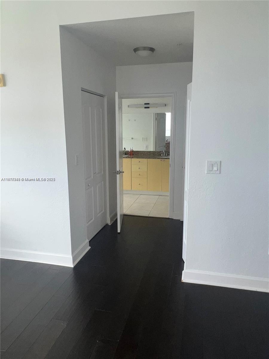 Royal Poinciana Hollywood, FL 33020 - Photo 24 of 26 a view of an empty room with wooden floor and a window