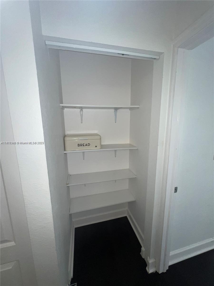 Royal Poinciana Hollywood, FL 33020 - Photo 25 of 26 a view of walk in closet with empty racks