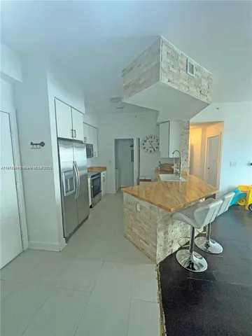 a living room with stainless steel appliances kitchen island granite countertop furniture and a kitchen view