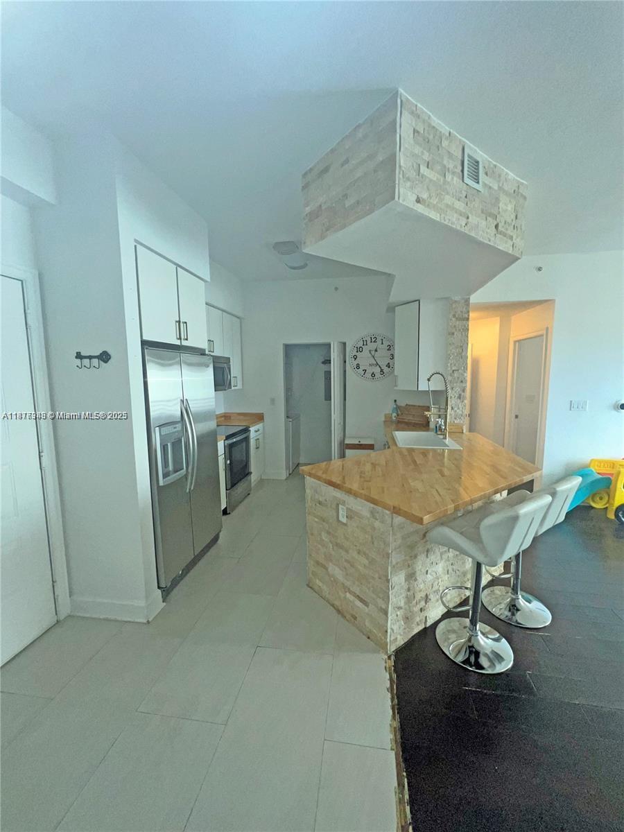 Royal Poinciana Hollywood, FL 33020 - Photo 8 of 26 a living room with stainless steel appliances kitchen island granite countertop furniture and a kitchen view