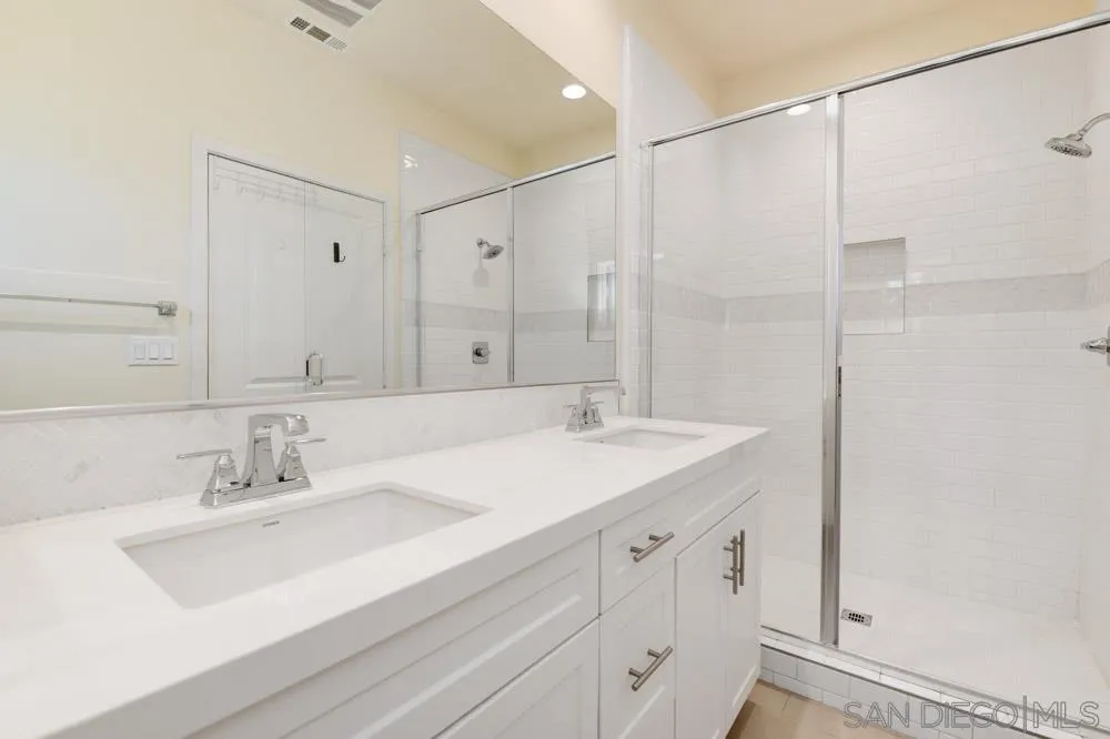 4314 Star Path Way, Unit 1 Oceanside, CA 92056 - Photo 18 of 40 a bathroom with a sink double vanity and a mirror