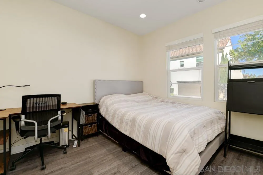 4314 Star Path Way, Unit 1 Oceanside, CA 92056 - Photo 24 of 40 a bedroom with a bed and wooden floor