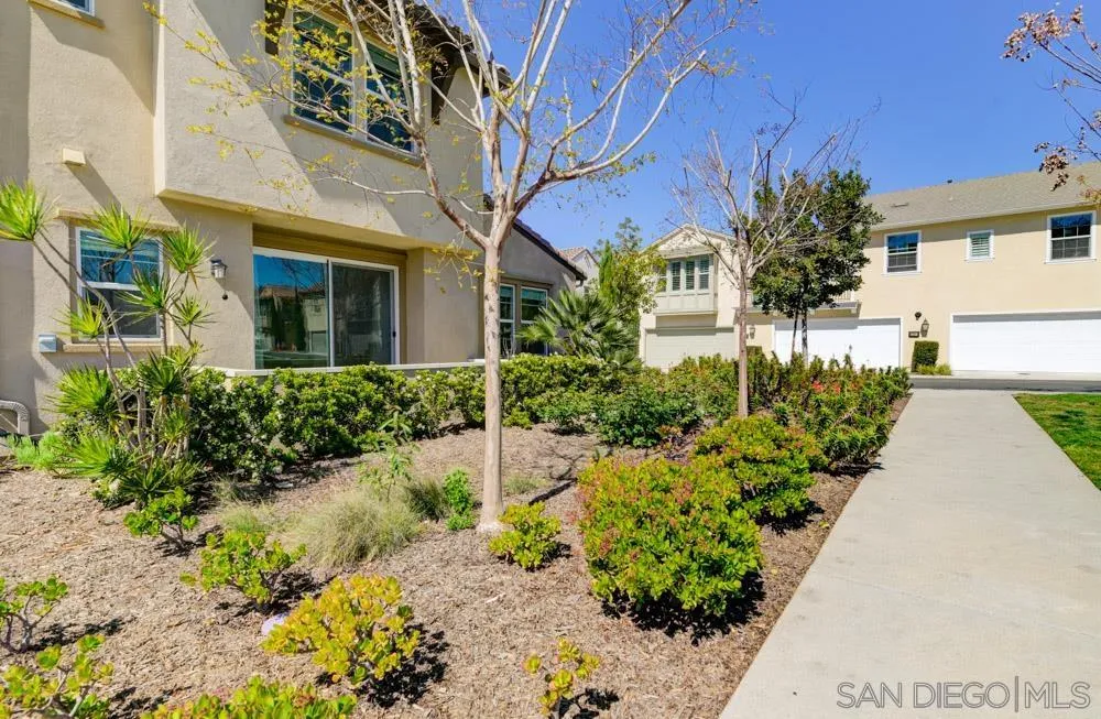 4314 Star Path Way, Unit 1 Oceanside, CA 92056 - Photo 29 of 40 a front view of a house with a yard