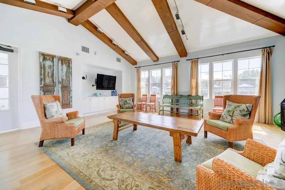 4314 Star Path Way, Unit 1 Oceanside, CA 92056 - Photo 32 of 40 a living room with patio furniture and a flat screen tv