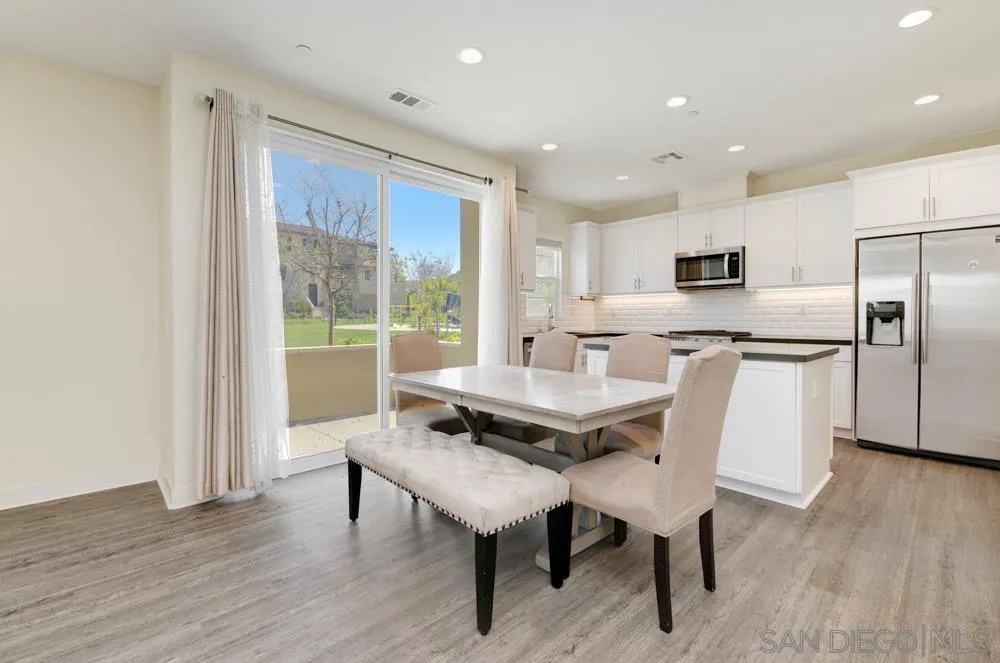 4314 Star Path Way, Unit 1 Oceanside, CA 92056 - Photo 8 of 40 a view of a dining room with furniture and wooden floor