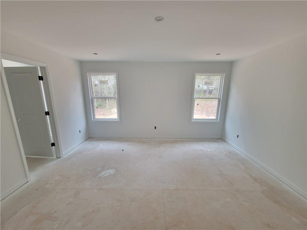 348 Silverleaf Trail Bethlehem, GA 30620 - Photo 11 of 30 a view of an empty room with windows