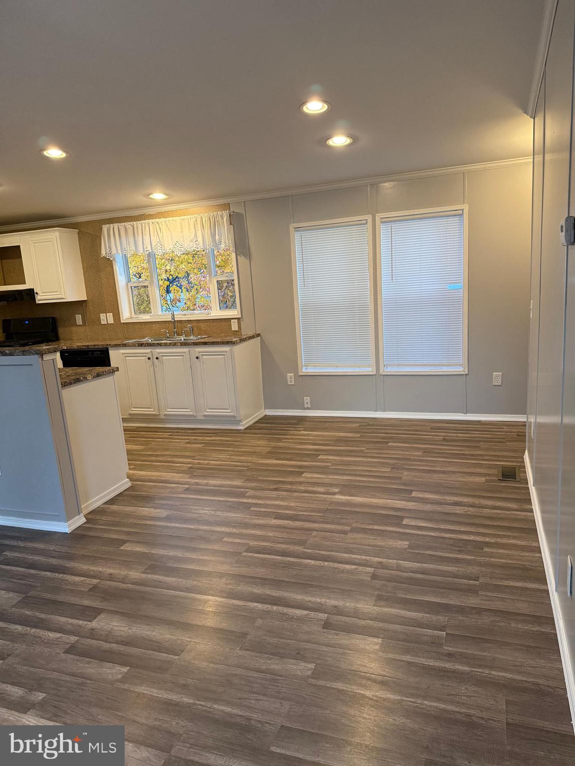 45 Chesapeake Mobile Court Hanover, MD 21076 - Photo 3 of 17 an empty room with wooden floor and windows