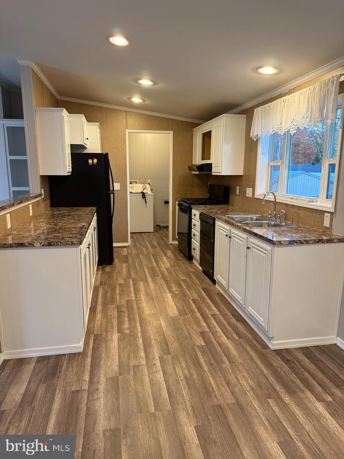 45 Chesapeake Mobile Court Hanover, MD 21076 - Photo 5 of 17 a large kitchen with granite countertop a sink and a stove top oven