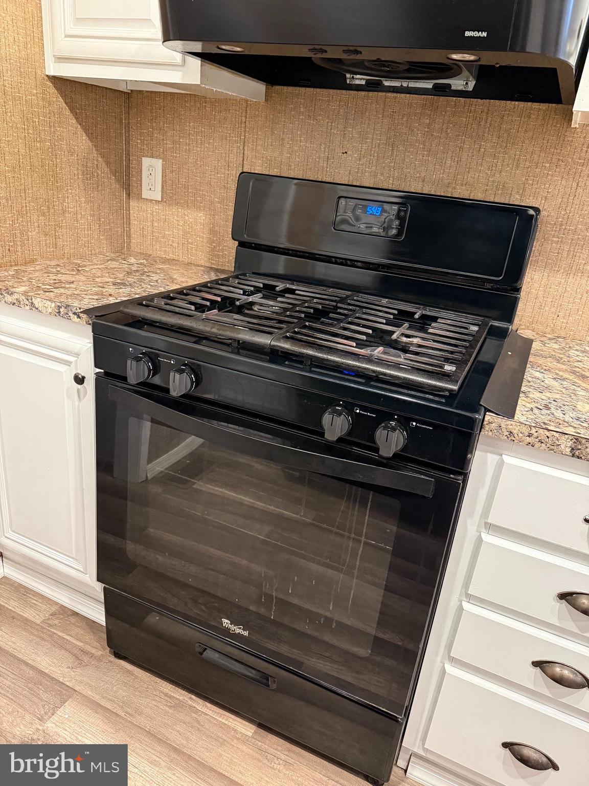 45 Chesapeake Mobile Court Hanover, MD 21076 - Photo 6 of 17 a stove top oven sitting inside of a kitchen