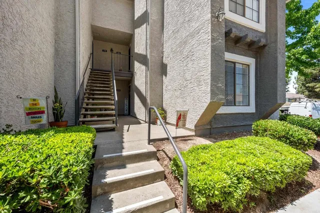 a view of a house with entrance and garden