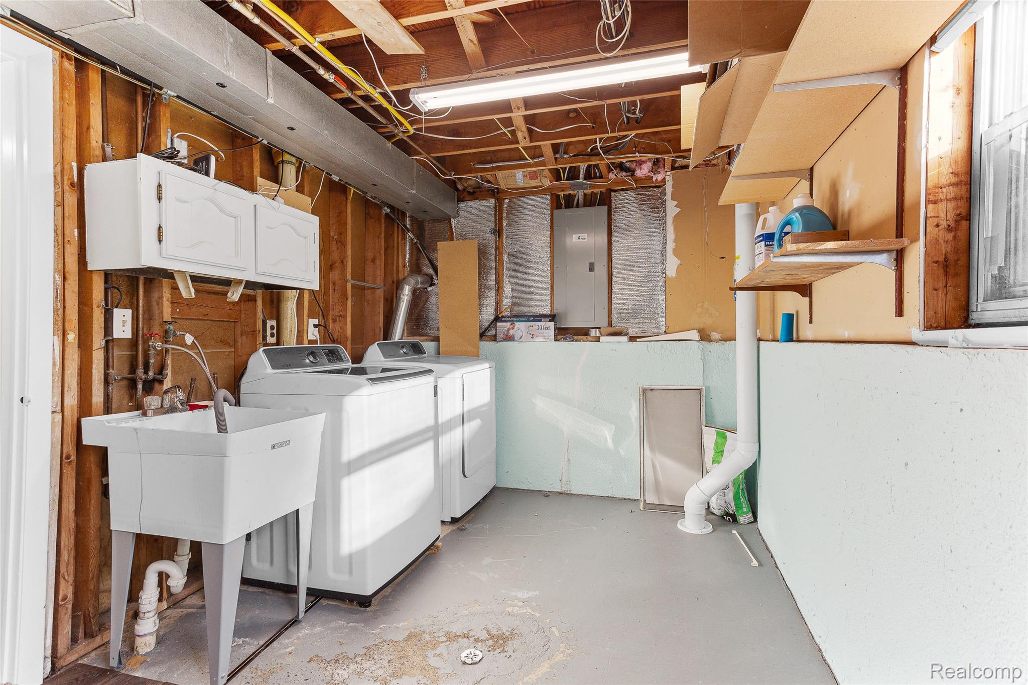 22582 Winfield Road Novi, MI 48375 - Photo 37 of 37 Dedicated laundry area featuring a utility sink, upper cabinetry, and a concrete floor