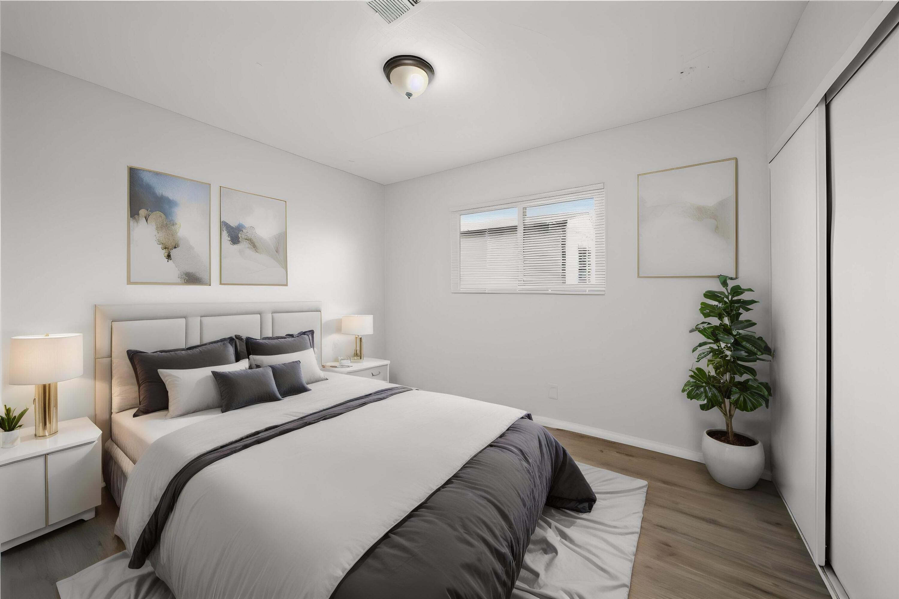 3360 West Roxbury Street Rosamond, CA 93560 - Photo 11 of 23 a bedroom with a large bed and a potted plant