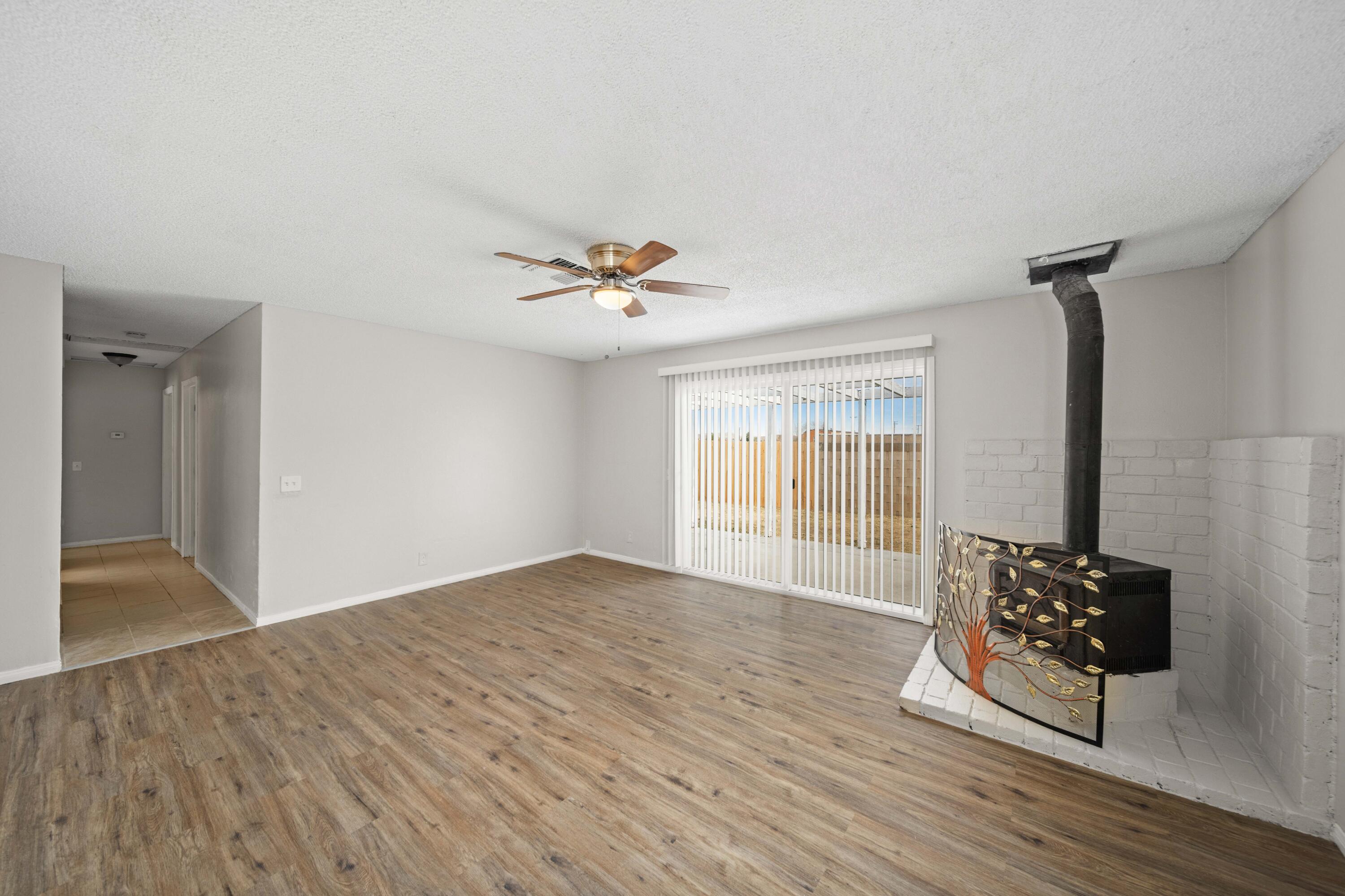 3360 West Roxbury Street Rosamond, CA 93560 - Photo 14 of 23 a view of an empty room with a window and wooden floor