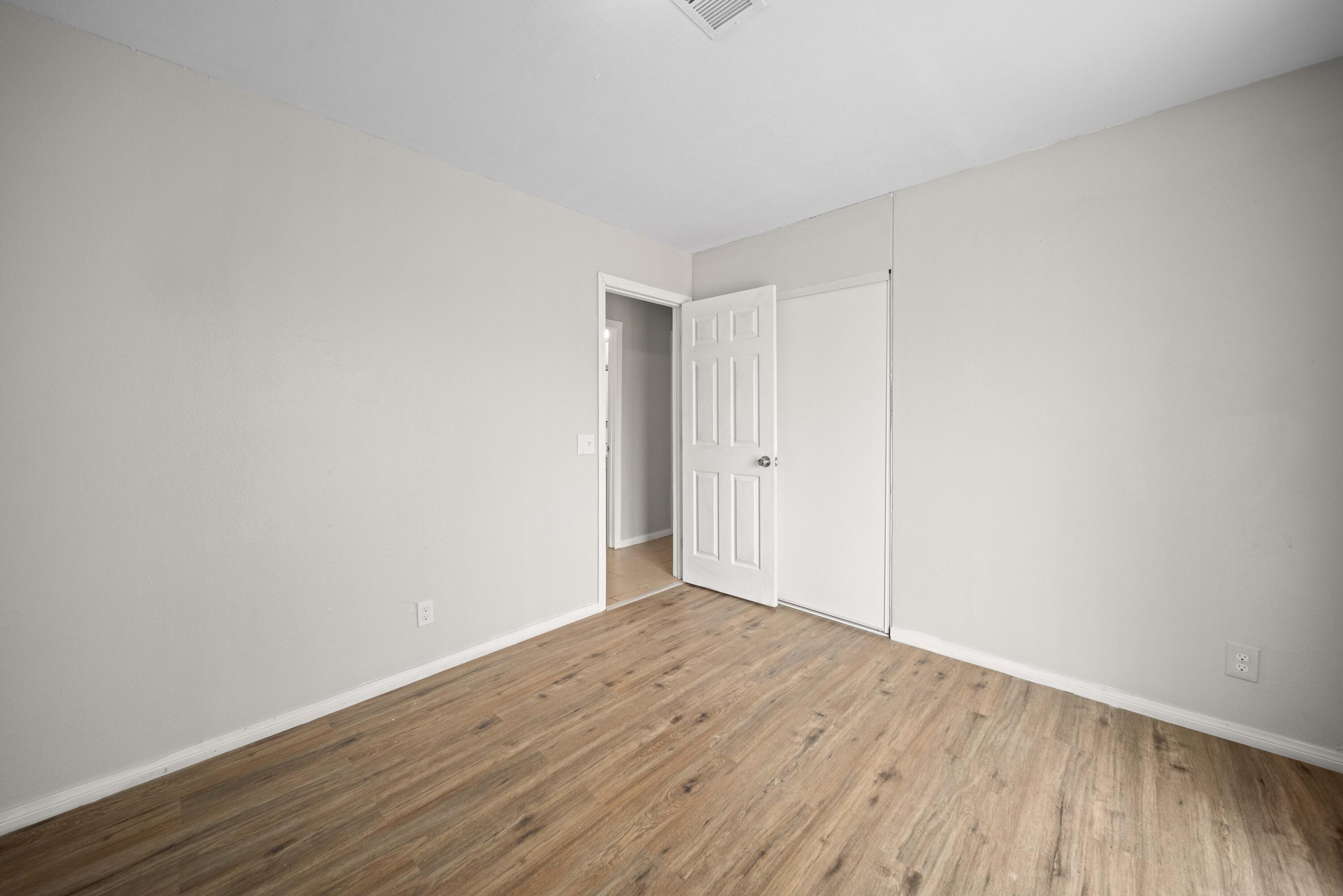 3360 West Roxbury Street Rosamond, CA 93560 - Photo 18 of 23 a view of an empty room with wooden floor