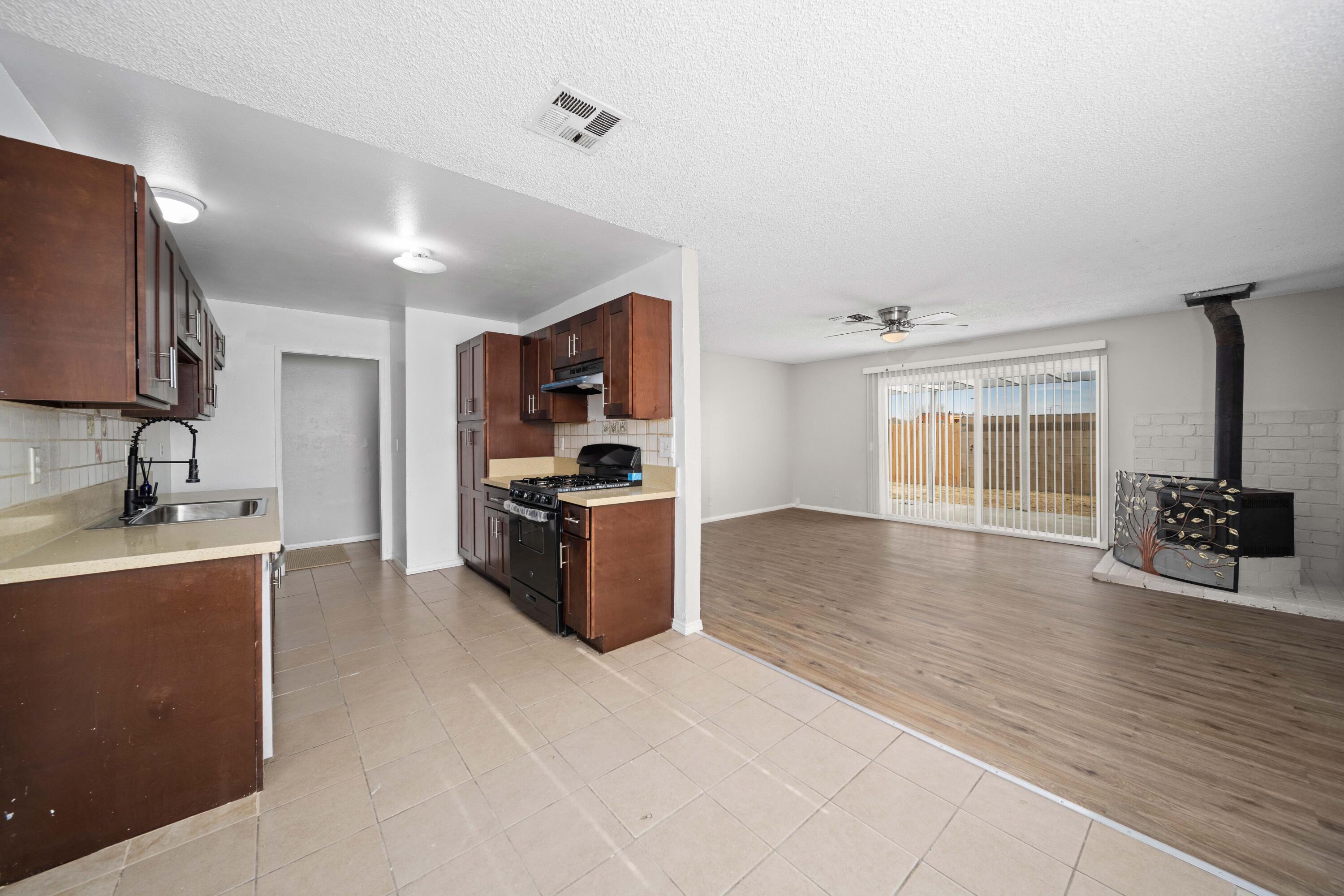 3360 West Roxbury Street Rosamond, CA 93560 - Photo 5 of 23 a view of a kitchen with a sink and a refrigerator